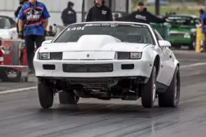 White 86 Camaro drag racing